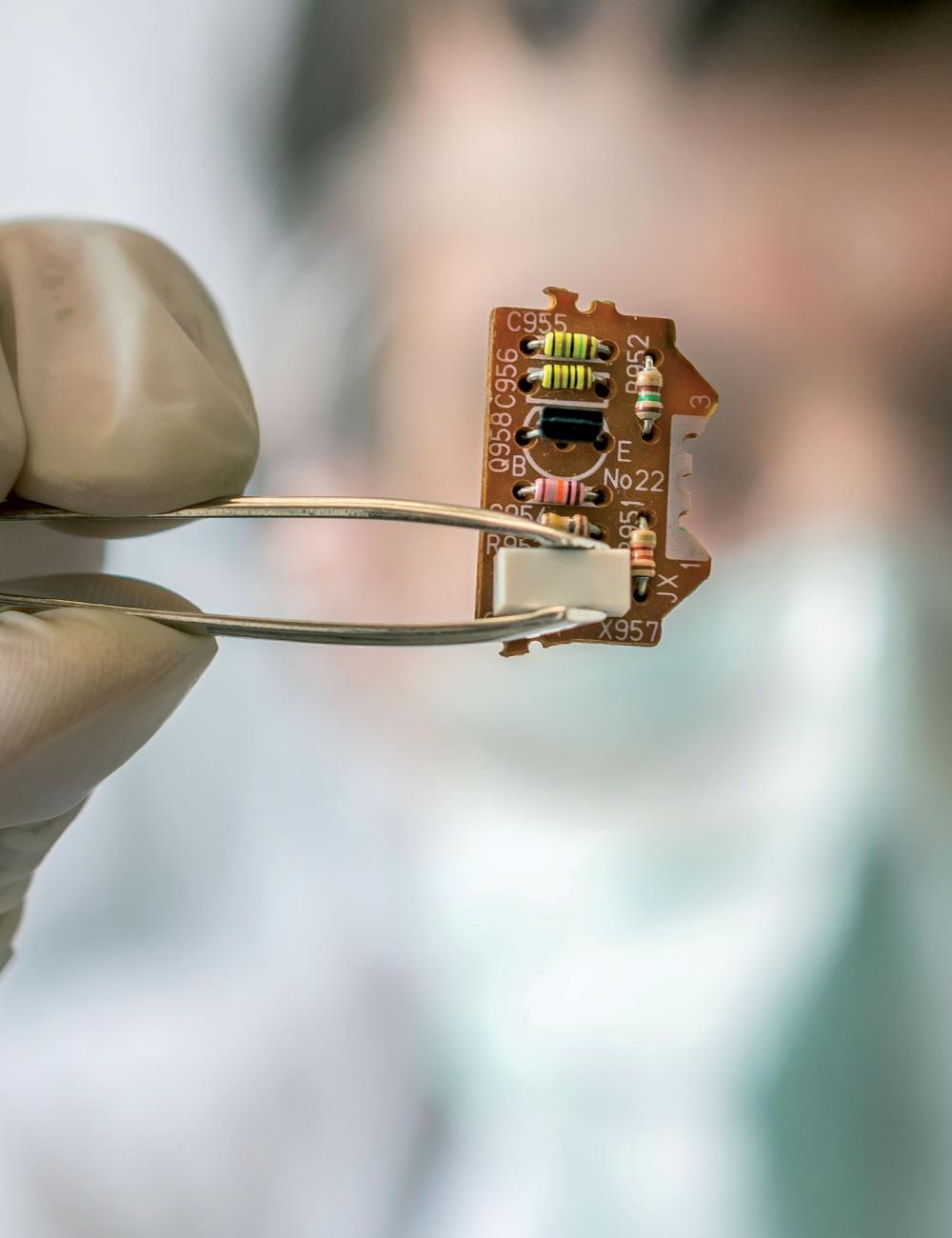 Lab tech holding a microchip